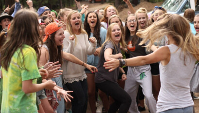 Girls laughing in circle.