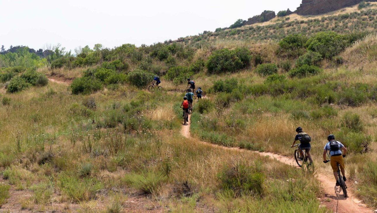 Boys biking up mountain.