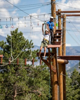 Camper zip lining on the challenge course.