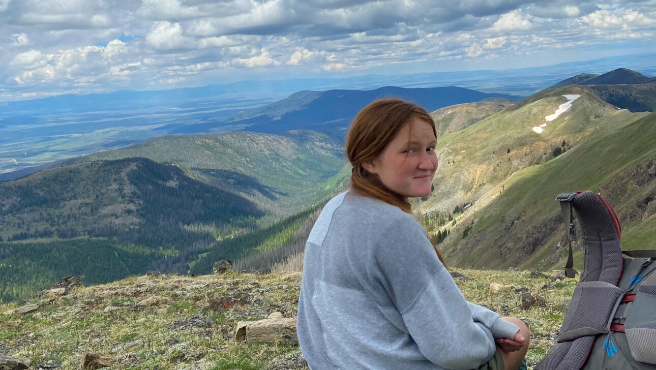 Girl looking back on mountain.