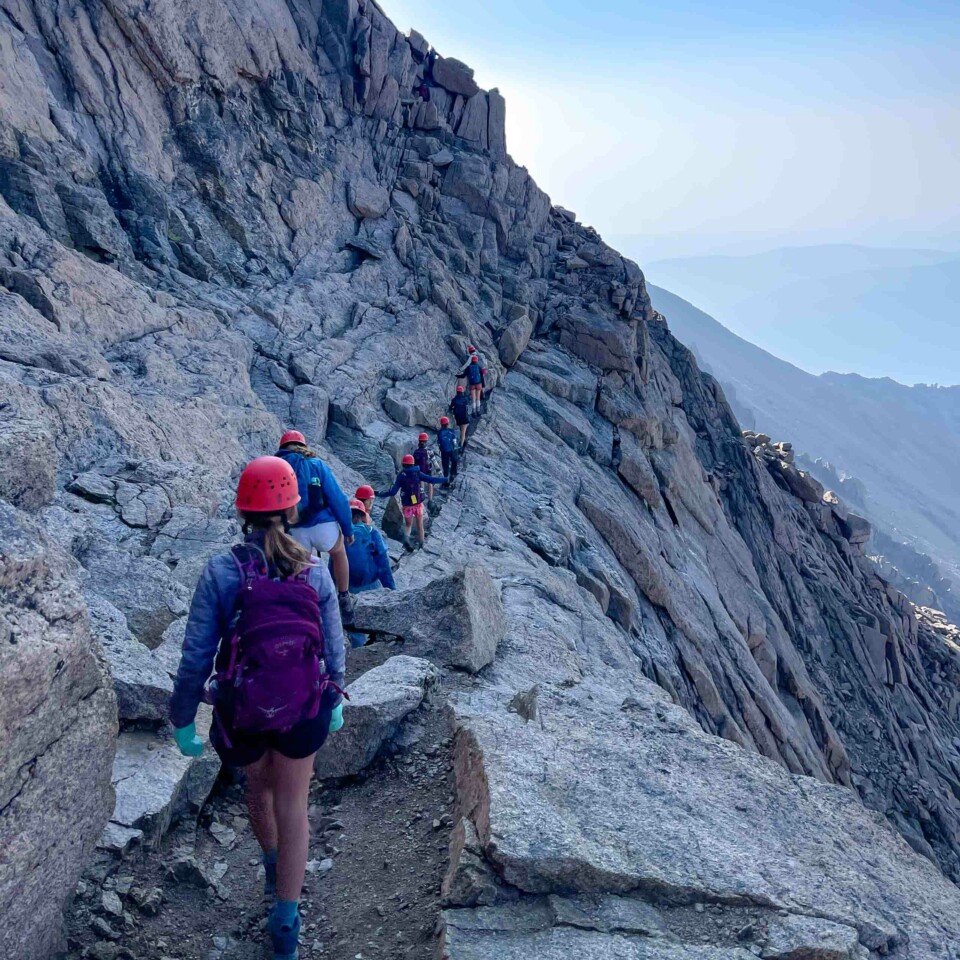 Girls hiking rock mountain.