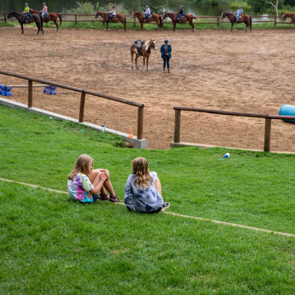 Girls sitting on grass.