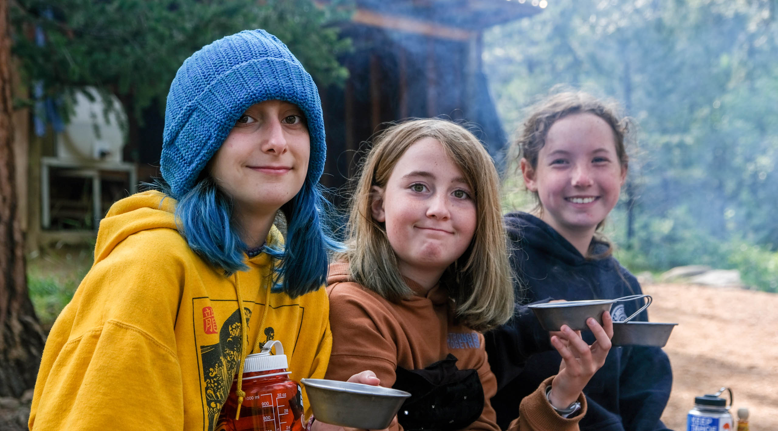 Girls smiling holding bowls.