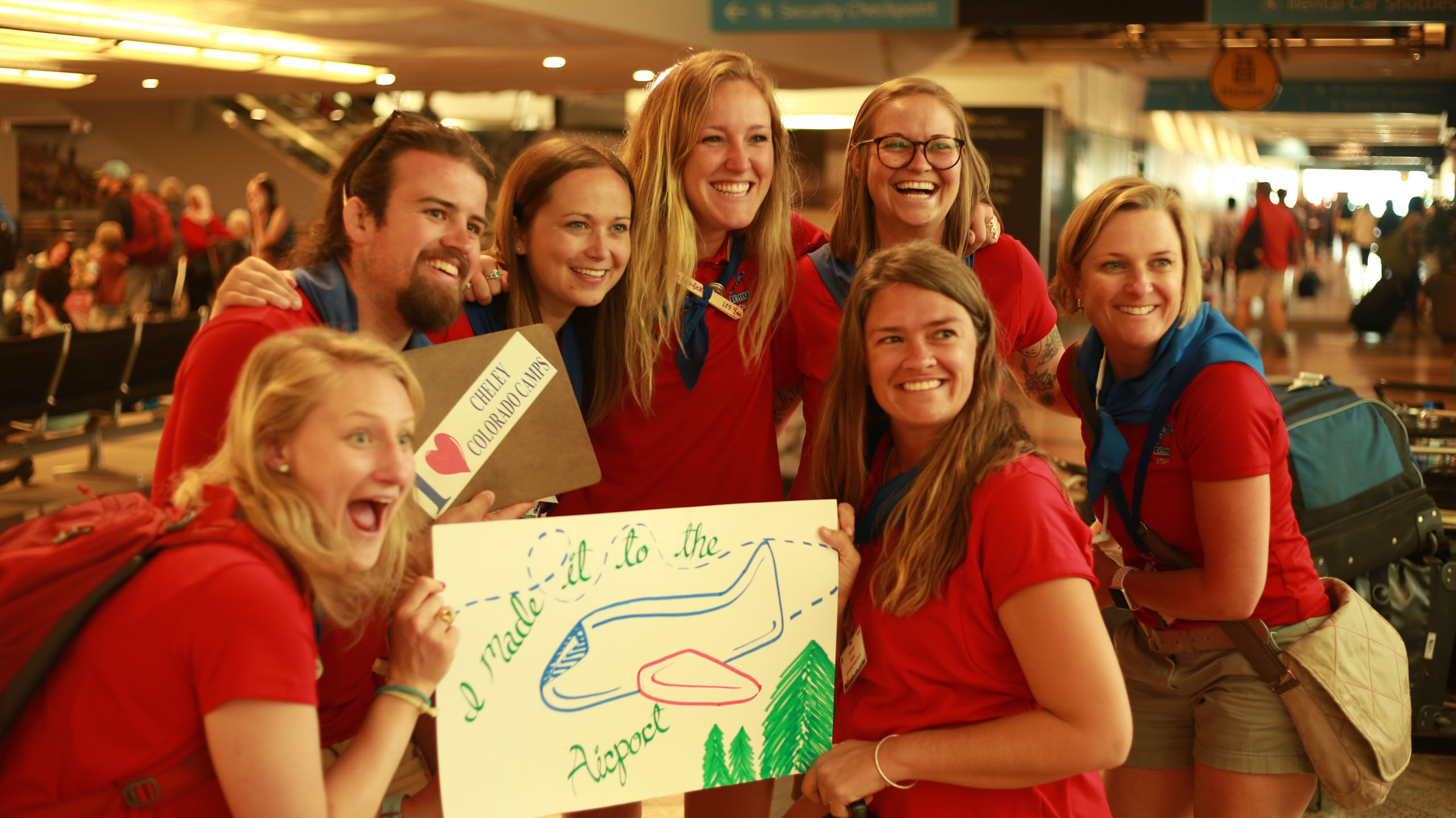 Group of counselors holding sign.