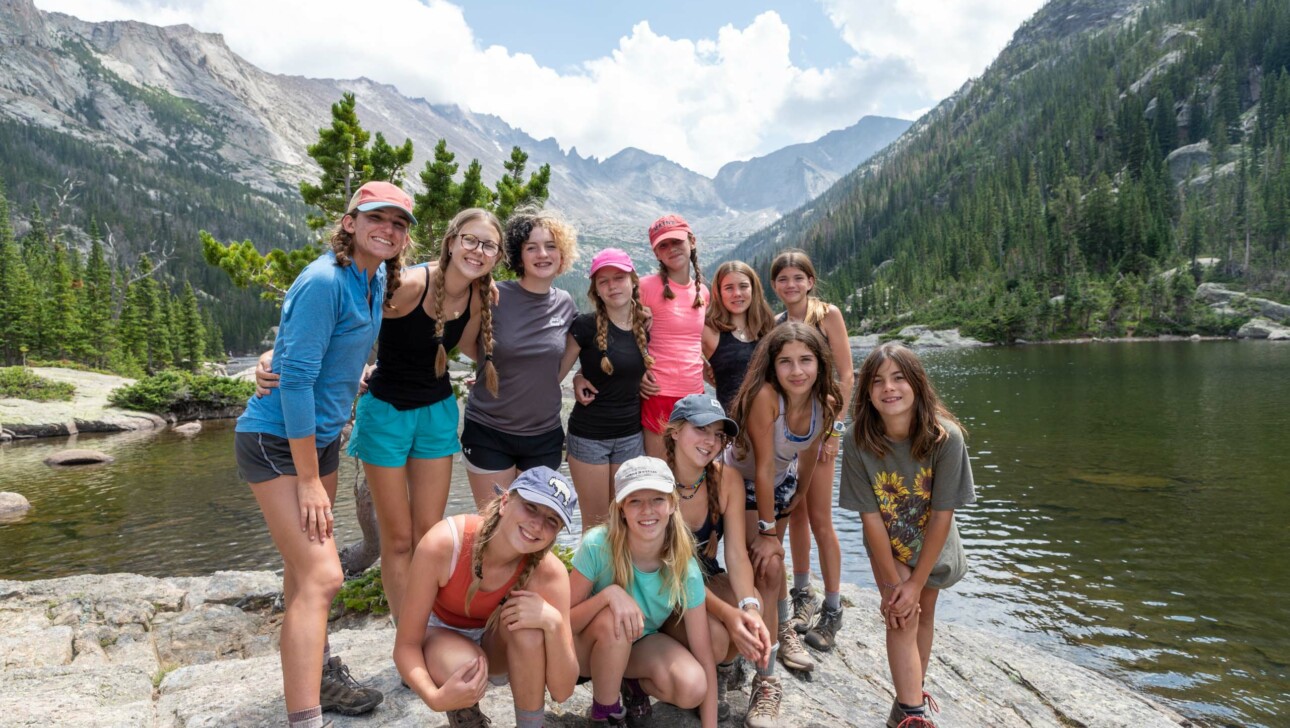 Group of girls smiling on mountain.