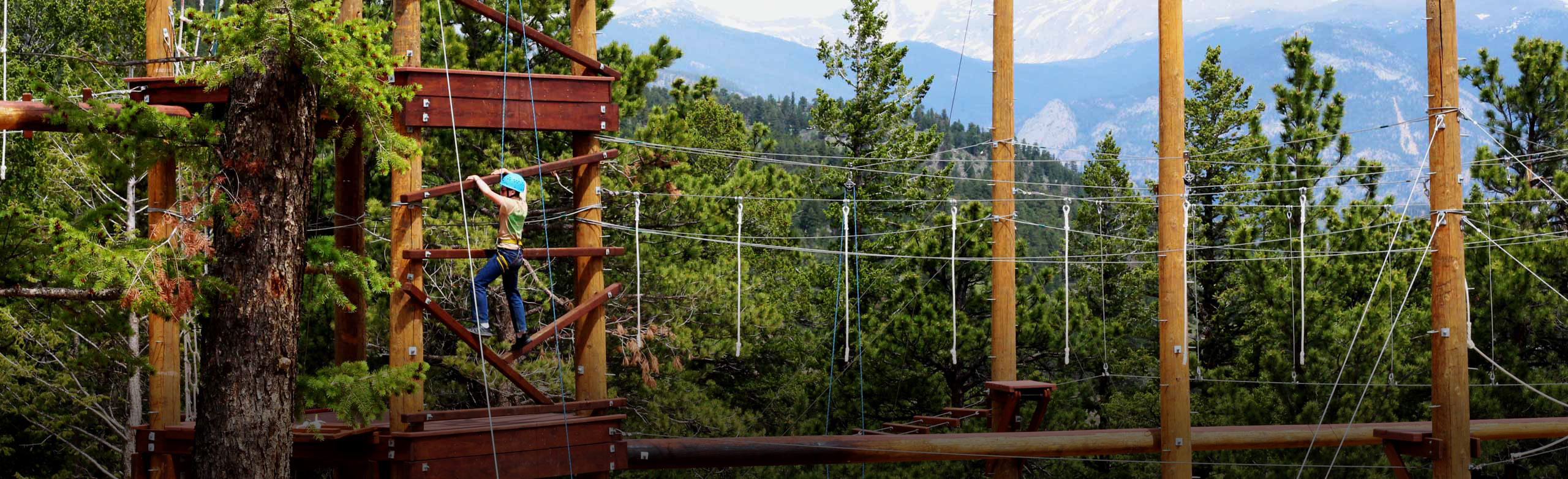 Girl on zipline obstacle course.