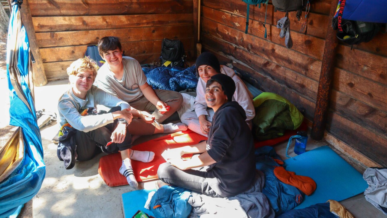 Kids smiling in cabin.