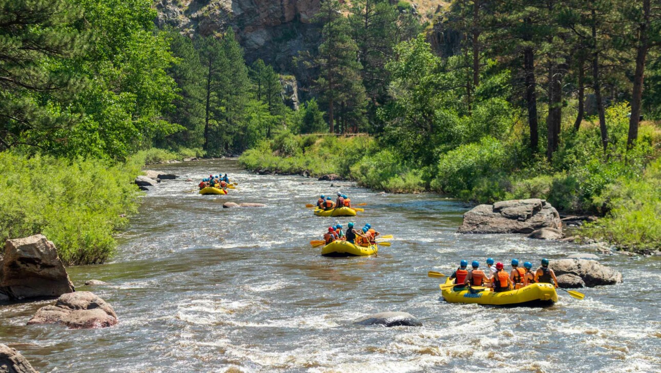 Kids in life rafts on river.