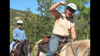 Two people horseback riding.