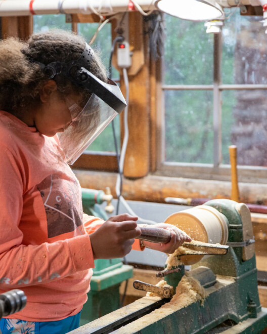 Camper in the woodworking shop working on a project.
