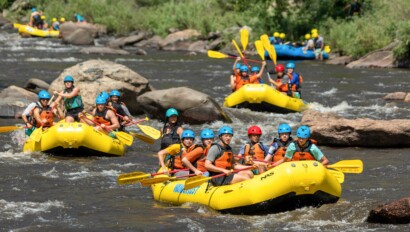 Three yellow rafts with people.