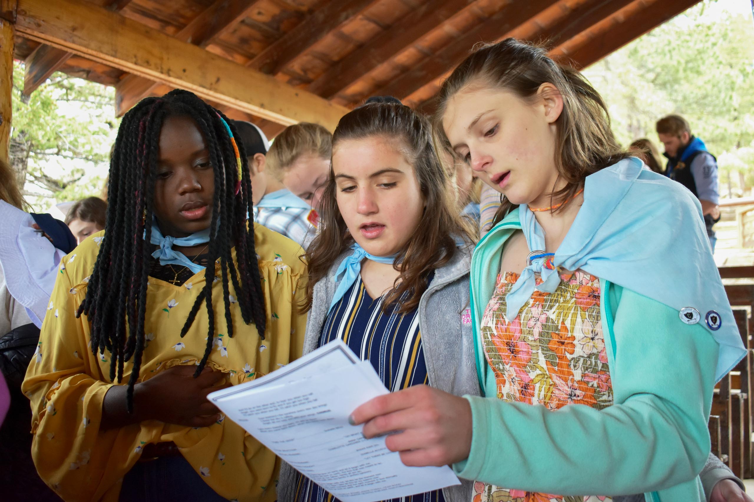 Girls reading paper.