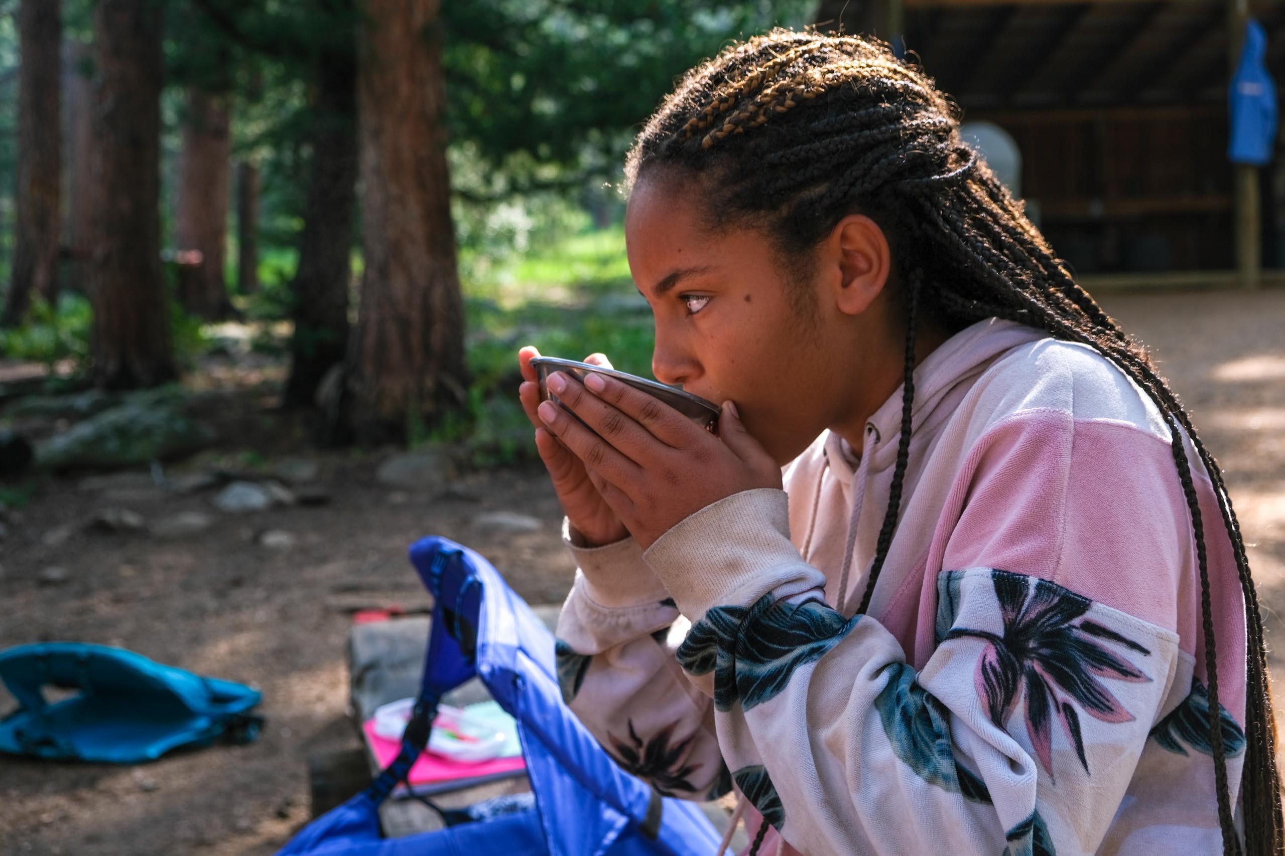 Girl drinking from bowl.