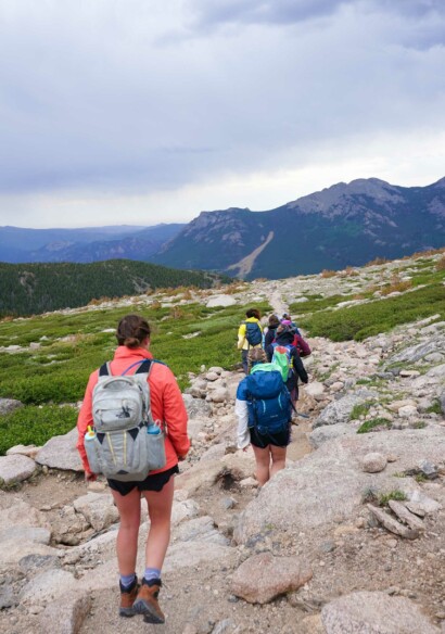 Girls hiking up mountain.