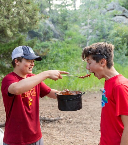 Boys feeding each other.