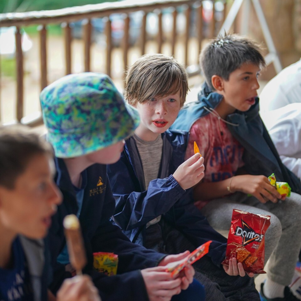 Kids sitting eating snacks.