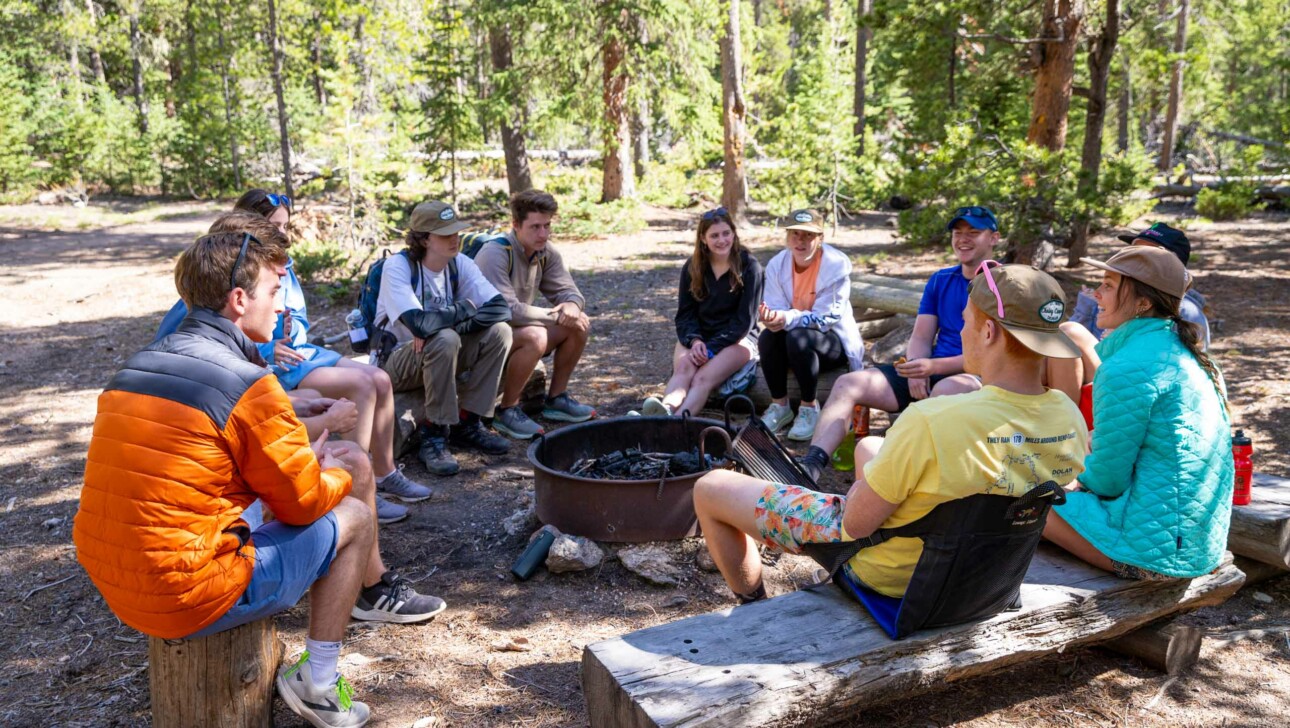 People sitting around campfire.