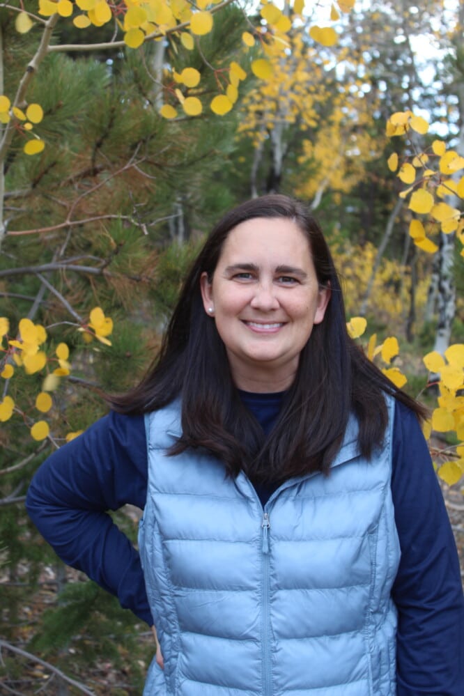 Portrait of Kim Betts in front of yellow aspens