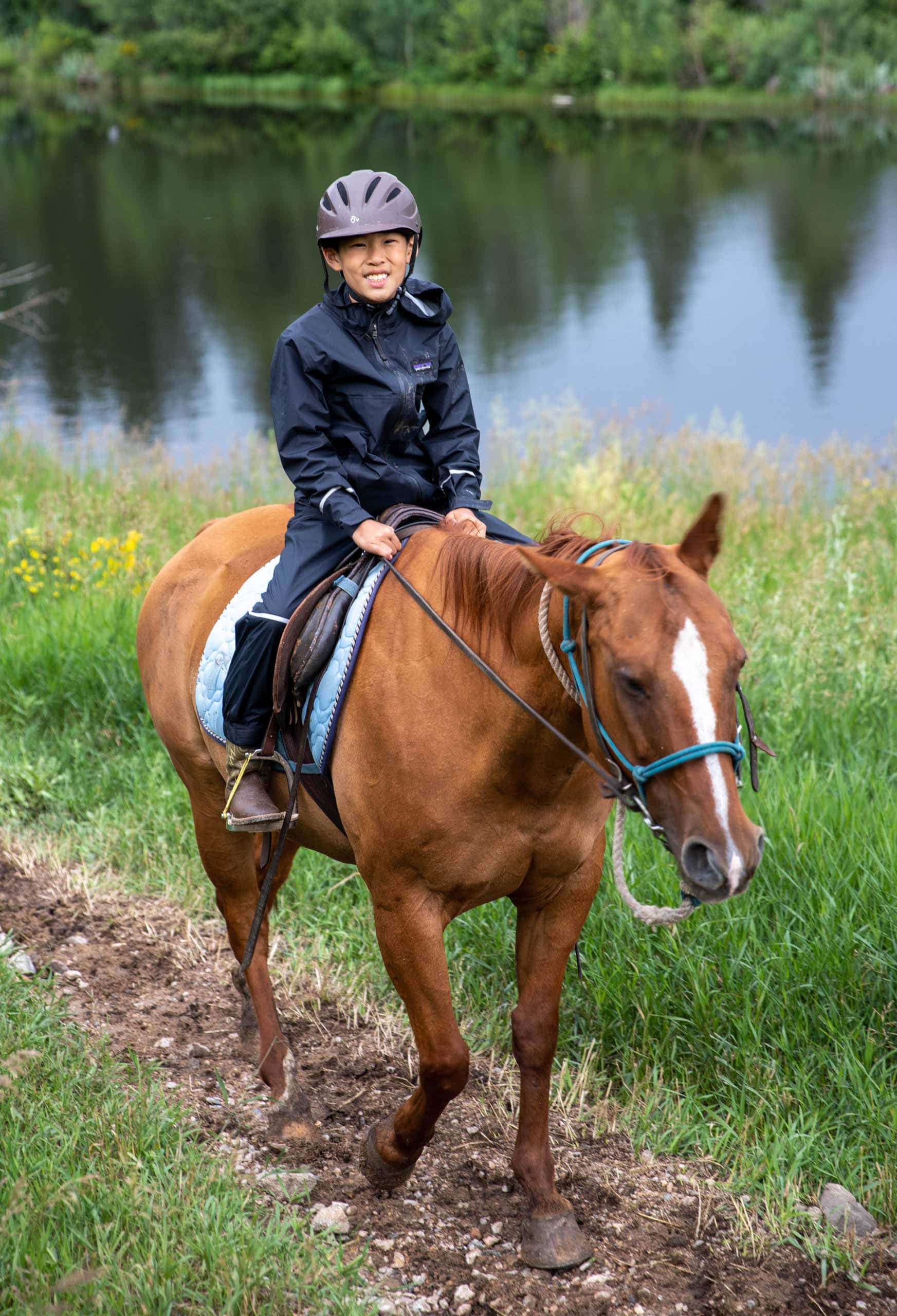 Camper on a horse on a trail.