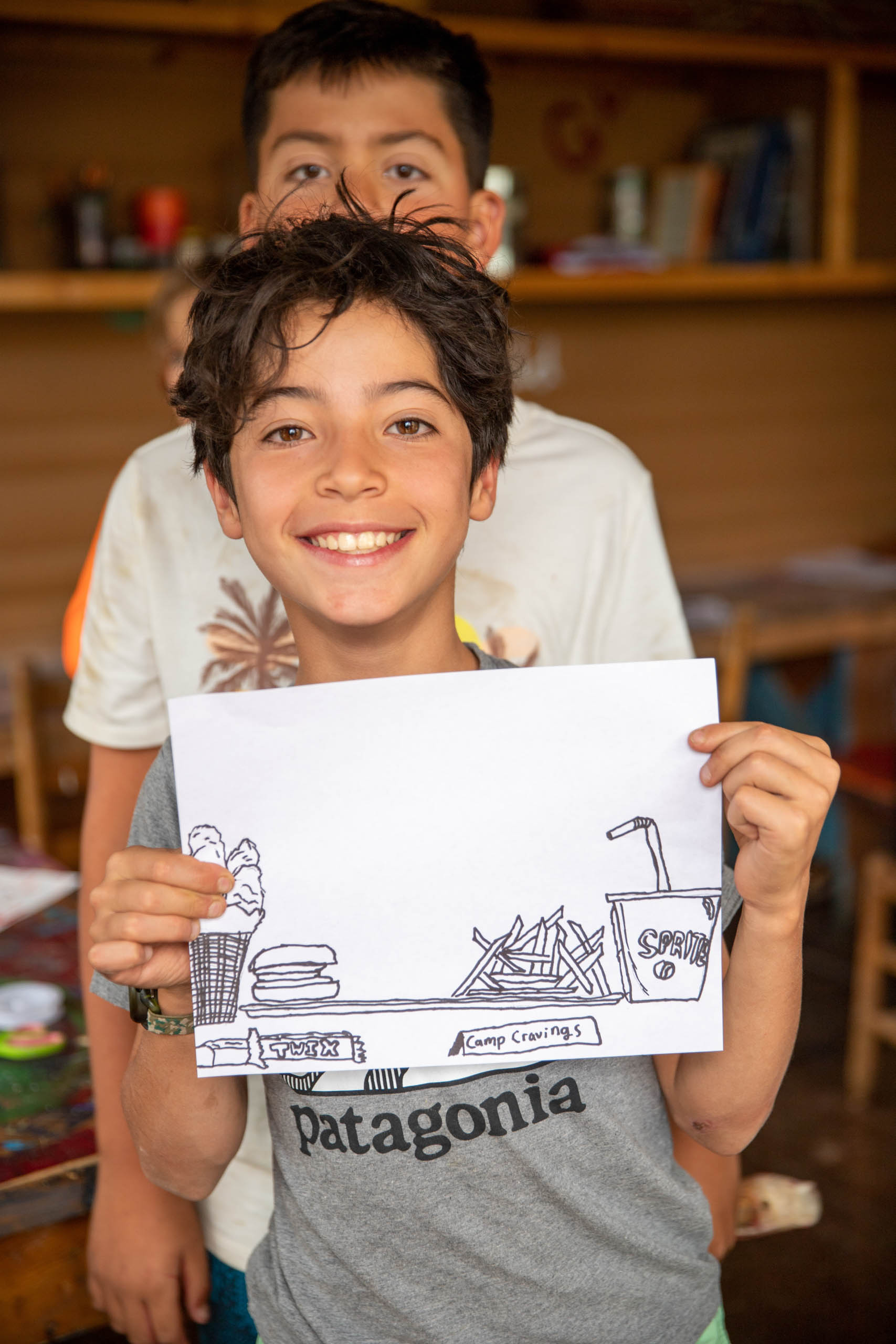 Camper showing his drawing.