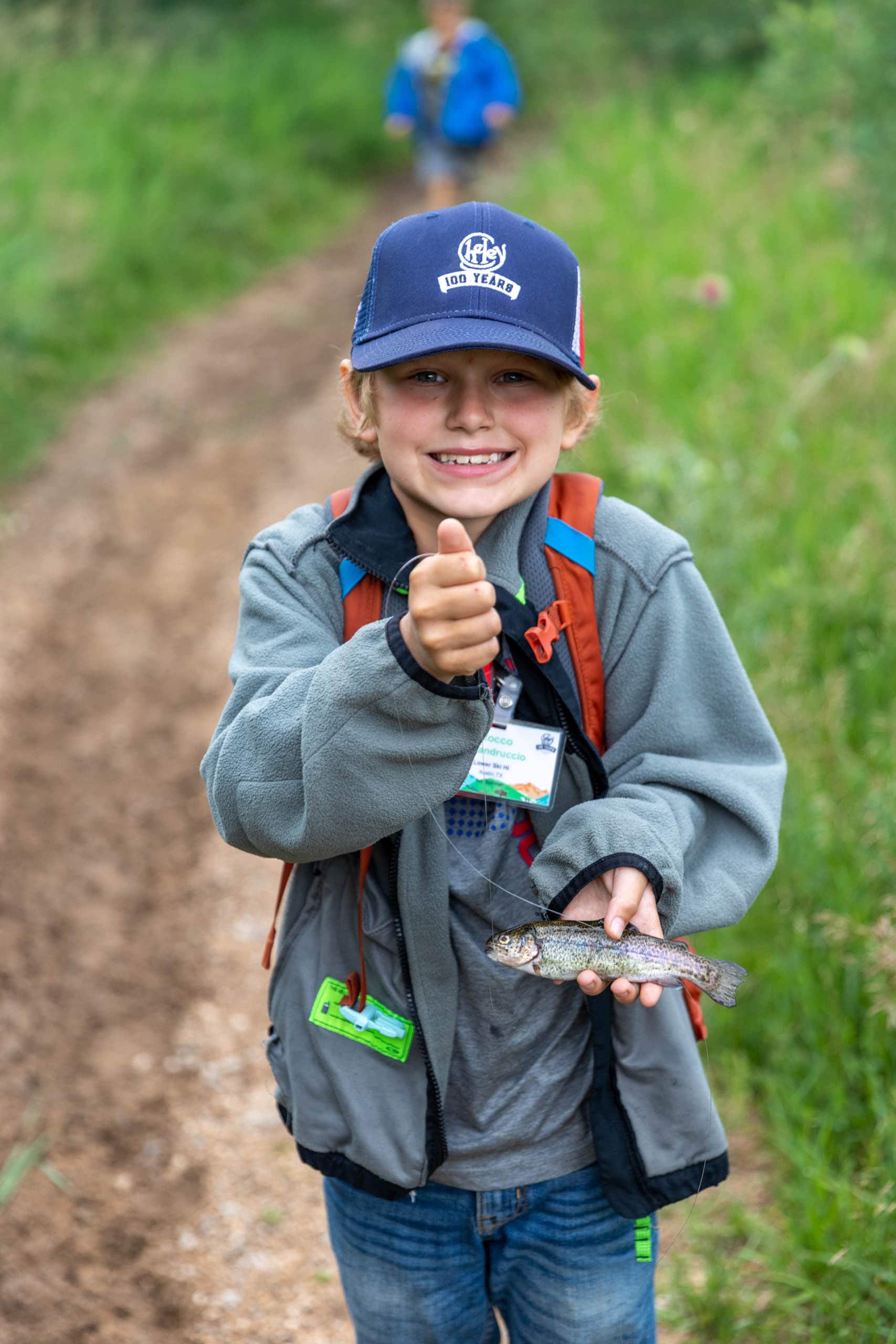 Camper showing the fish he caught.
