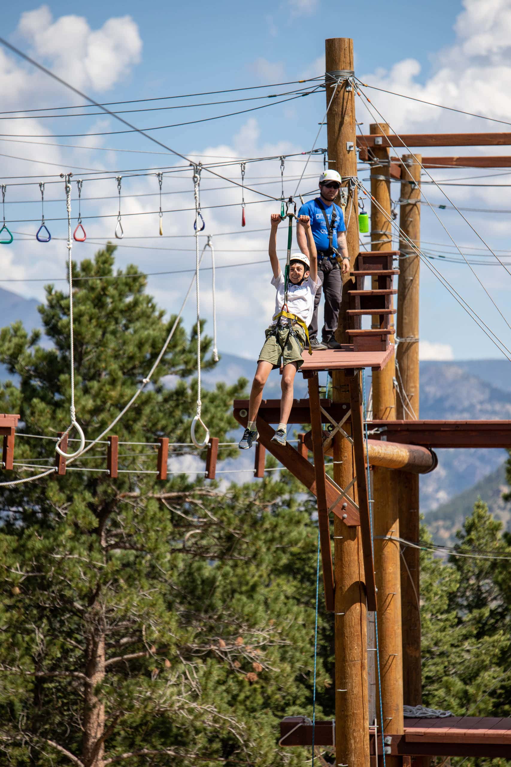 Camper zip lining on the challenge course.