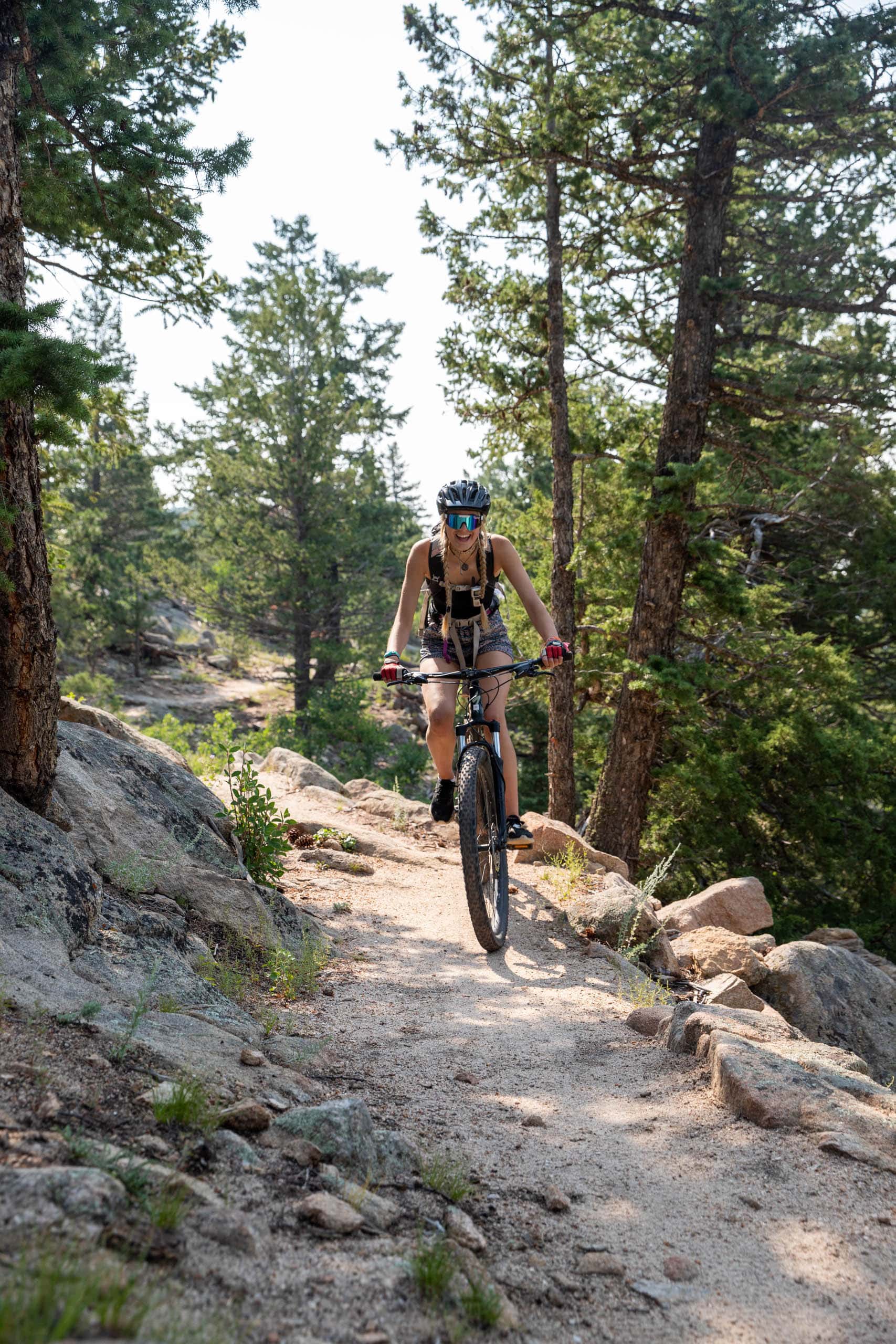 Camper riding mountain bike on trail.