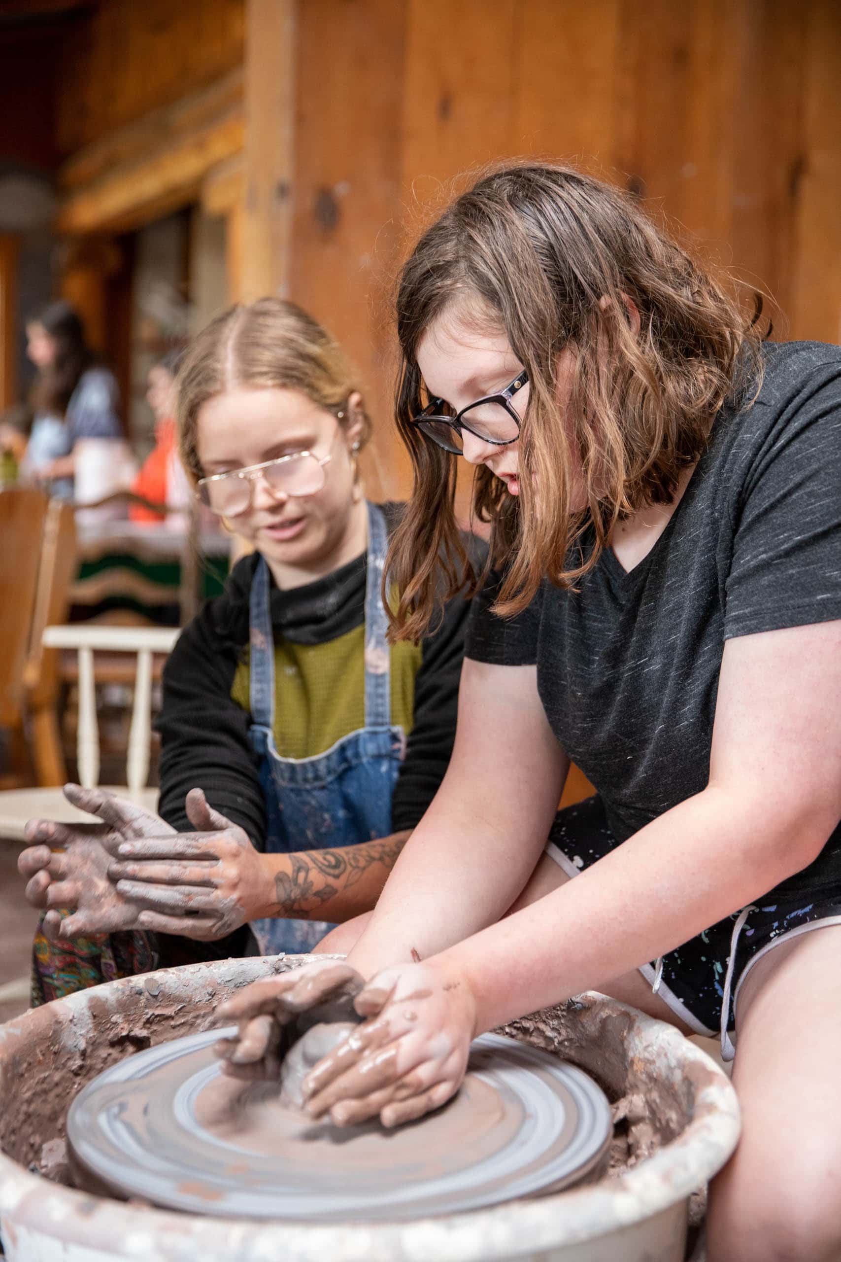 Girl working on the pottery wheel.