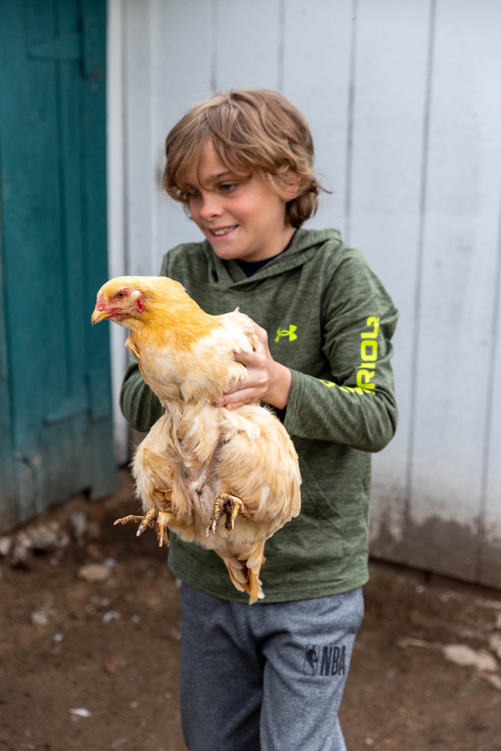 Camper holding a chicken.