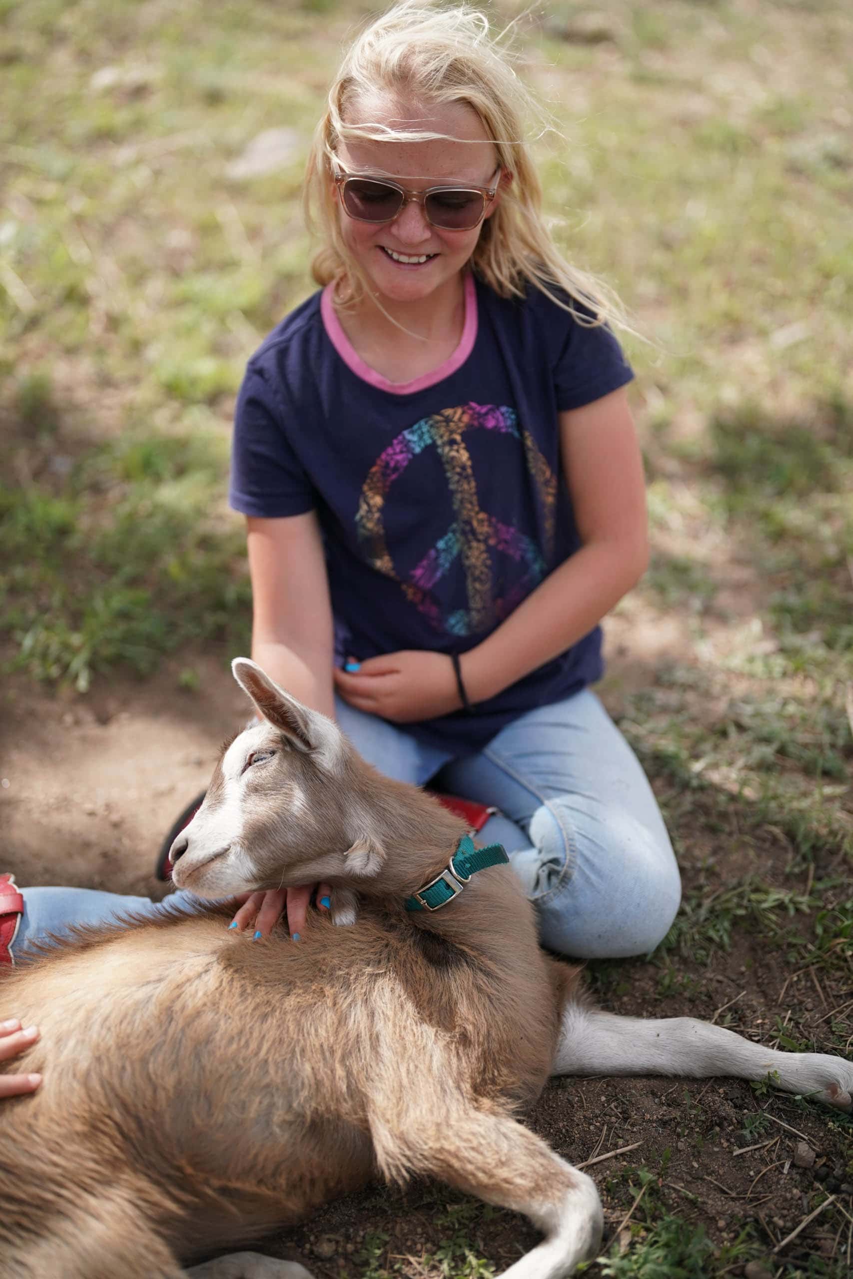 Camper petting a goat.