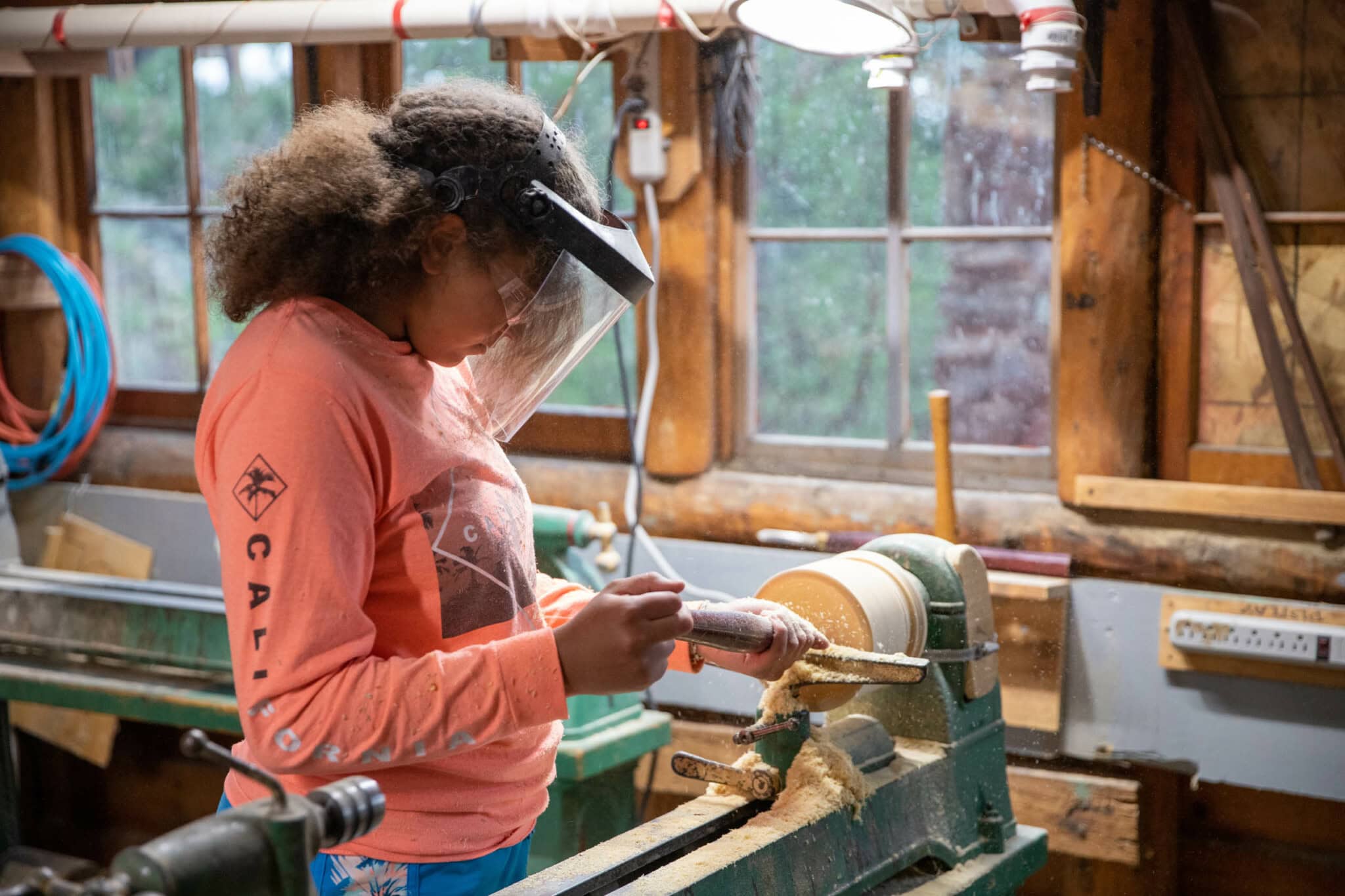 Camper in the woodworking shop working on a project.